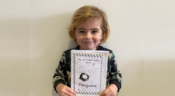 Frankie with his book about penguins